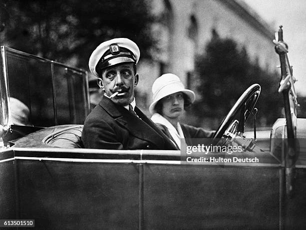 King Alfonso XIII drives a car at Deauville, France.