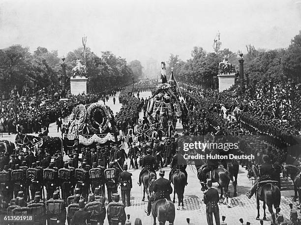 The funeral procession of Victor Hugo , the French poet and writer, watched by large crowds in Paris, 1885.