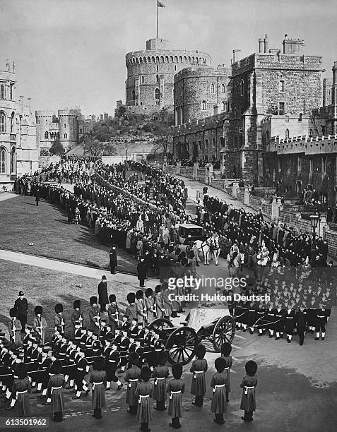 The coffin of the late King George VI passes through the grounds of Windsor Castle during his funeral procession.