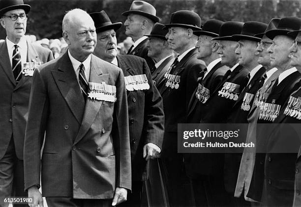 Henry, Duke of Gloucester, inspects a group of World War I veterans during a 50th anniversary celebration at Buckingham Palace.