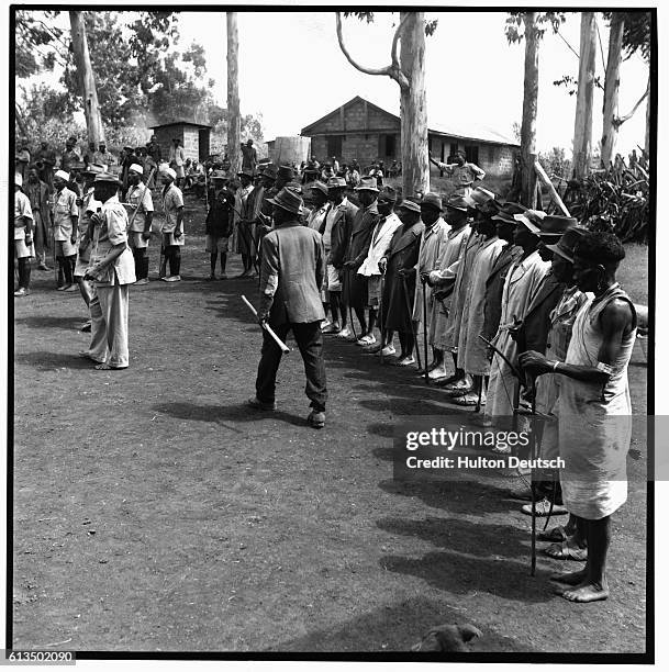 Irregular police volunteers line up at a police compound at Fort Hall in preparation for a raid on a Mau Mau village during the 1948-52 war between...