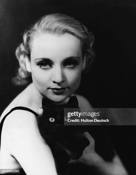 Carole Lombard poses with her cat in the 1930s. Lombard acted in many popular films and was married to William Powell and later to Clark Gable. She...