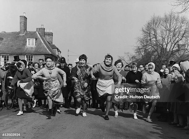 People watch as women take part in a pancake race at Onley.