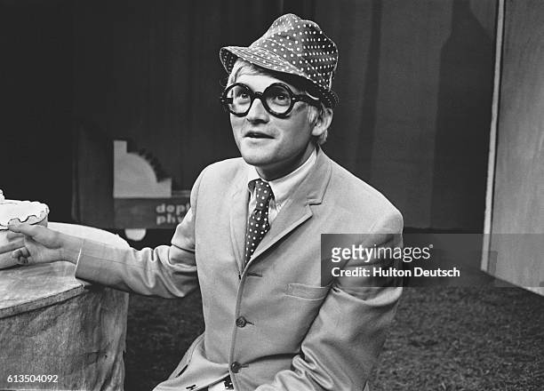 Portrait of the English artist, David Hockney, taken on the set of 'Ubo Roi' at the Royal Court Theatre in London, England. Besides the development...