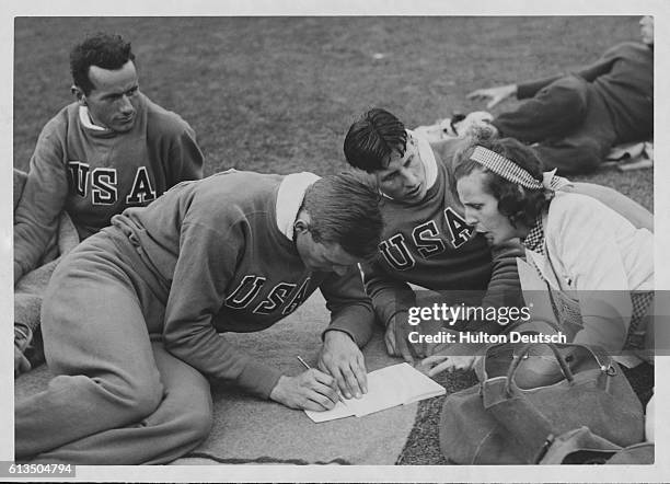 Film director Leni Riefenstahl chats with decathletes from the US Olympic team inlcuding the Olympic champion, Glen Morris. Berlin, 1936.