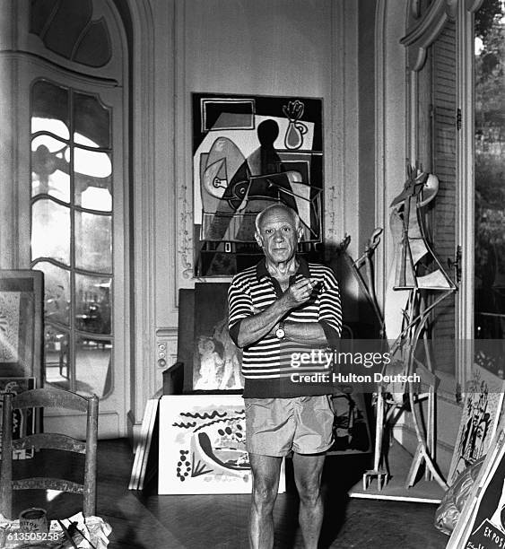 Spanish painter Pablo Piccasso, surrounded by artworks, at his villa La Californie in Cannes in 1955.