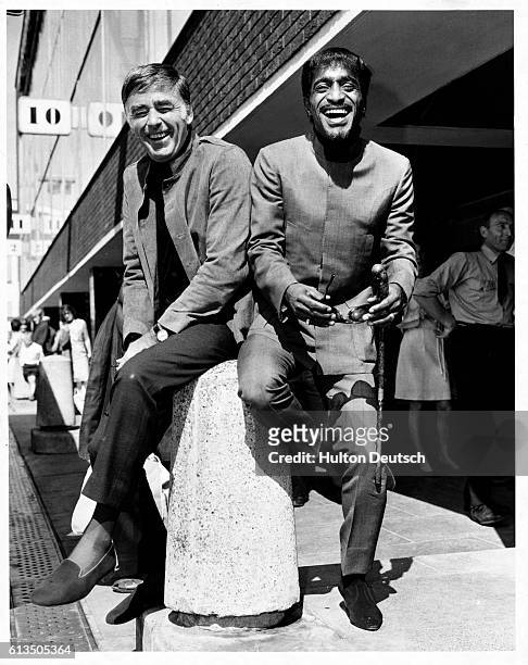 English film and TV actor meets American singer, dancer, and actor Sammy Davis Junior at Heathrow Airport, London, 1967. The two men are to appear in...