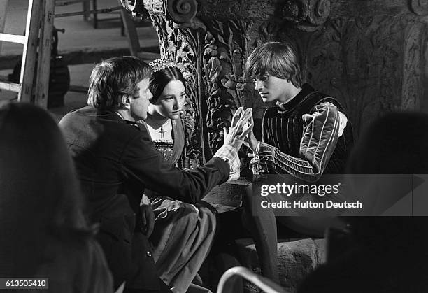 Film director Franco Zeffirelli directing Olivia Hussey and Leonard Whiting during the filming of Romeo and Juliet, 1967.