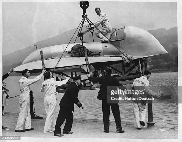 The hydroplane Empire Day, which was built by Edward Spurr and designed by Spurr and T. E. Lawrence , is lowered into Lake Windermere ready for an...