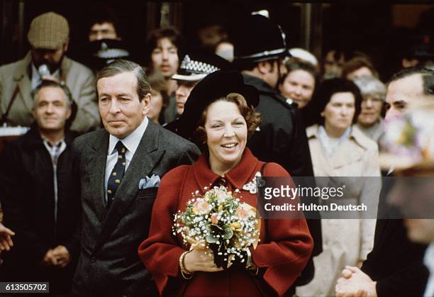 Beatrix, Queen of the Netherlands, and her husband, Prince Claus, pay a visit to a city shopping center during their state visit to Britain.