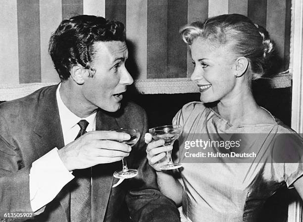 John Osborne the playwright and actor, and his bride, the actress Mary Ure, toast each other after their wedding in London, 1967. Ure plays the lead...