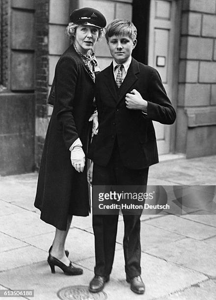 Lady Diana Cooper stands with her son, Alfred, in London after returning from Algiers.