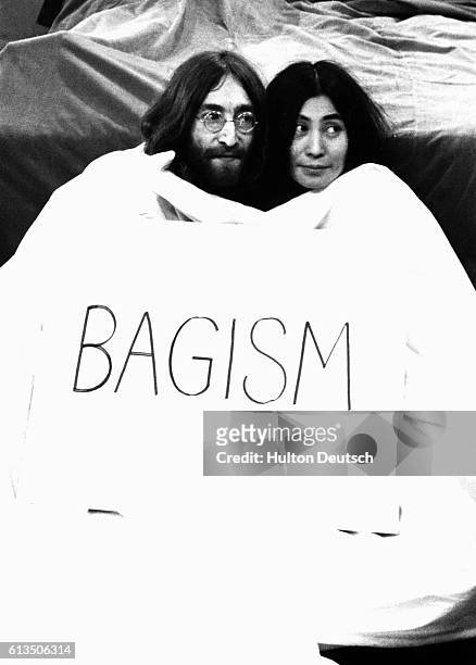 Ex-Beatle John Lennon and his wife Yoko Ono pop out of a big bag before appearing on the television programme Today.