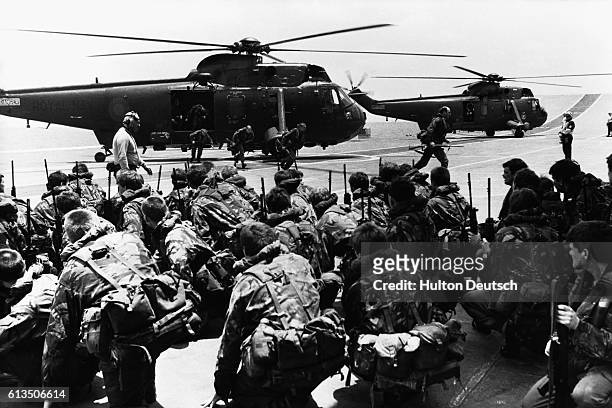 Commandos aboard the HMS Hermes prepare to be transferred to other ships to await deployment to the Falkland Islands.