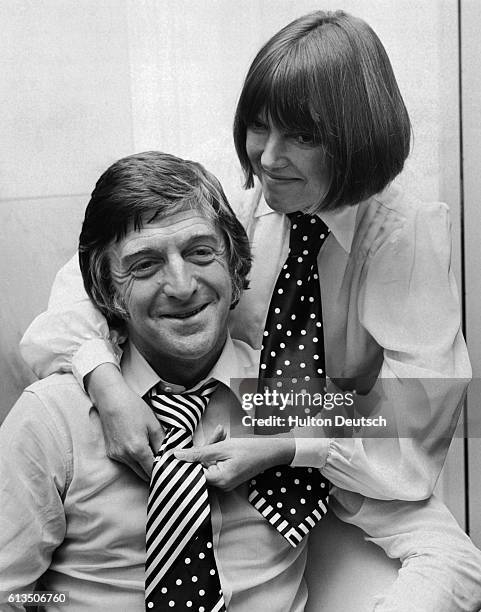 The fashion designer Mary Quant, tries out one of her new range of neckties on Michael Parkinson, the television presenter at the Savoy Hotel,...