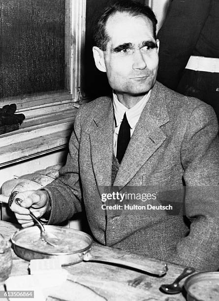 Nazi criminal Rudolf Hess eats stew in the Palace of Justice, Nuremberg, where he was sentenced to life imprisonment in 1946. | Location: Palace of...