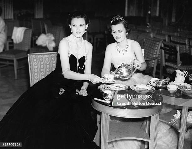 During the Beau Geste party at Claridges in London, England, nine famous beauties are grouped upon a stage in a "Bouquet Final", wearing jewels worth...