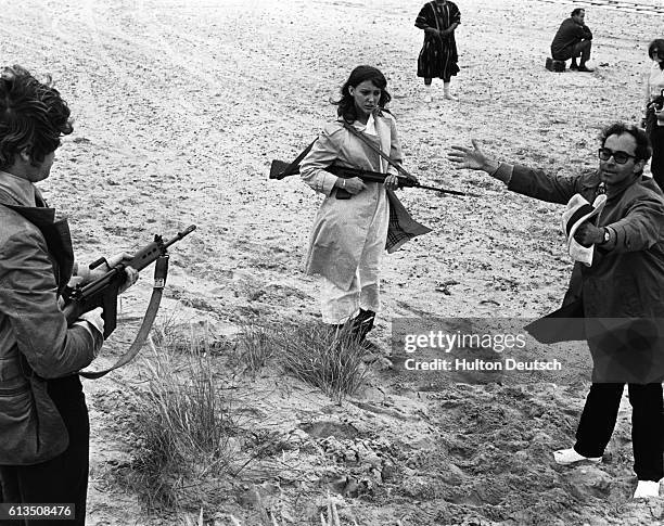 French film director Jean-Luc Godard, directs his wife, actress Anne Wiazemski in the film One Plus One being shot on the beach at Camber Sands, ca....