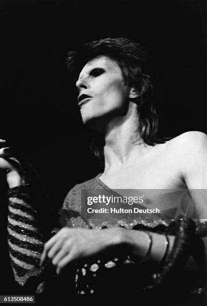 David Bowie in concert at the Hammersmith Odeon, in the persona of his alter ego Ziggy Stardust.