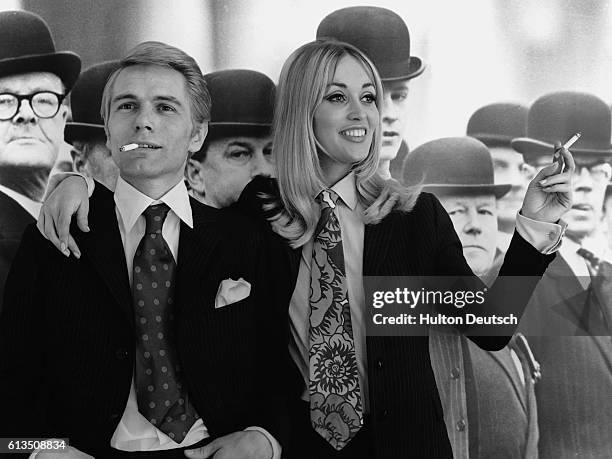 Adam Faith and Jackie Irving wearing his and her suits, 1967. English singer and actor Adam Faith with his wife Jackie Irving, 1967. The couple are...