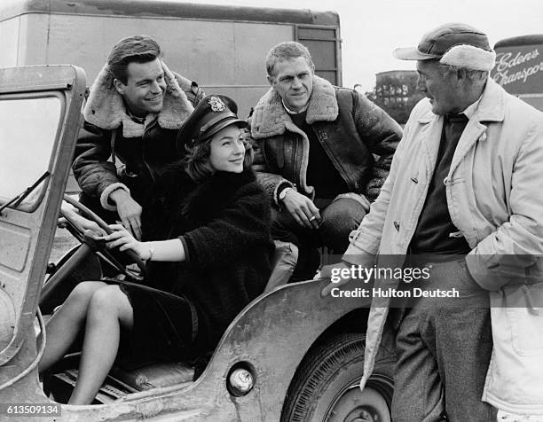 British actress Shirley Ann Field with American actors Robert Wagner and Steve McQueen , talking to director Philip Leacock , during location...