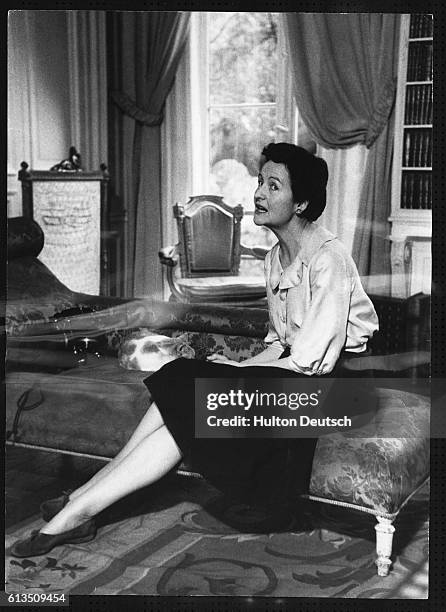 The English writer Nancy Mitford pictured seated inside her Paris apartment, 1956. Her novels include The Pursuit of Love , Love in a Cold Climate...