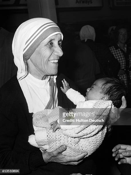Mother Teresa, of Calcutta, at London Airport in 1979, holding a child who had been named after her.