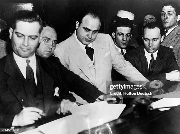 Al Capone, the gangster and so-called ruler of the Chicago underworld, signs a Bail Bond, signalling the beginning of his prosecution for failure to...