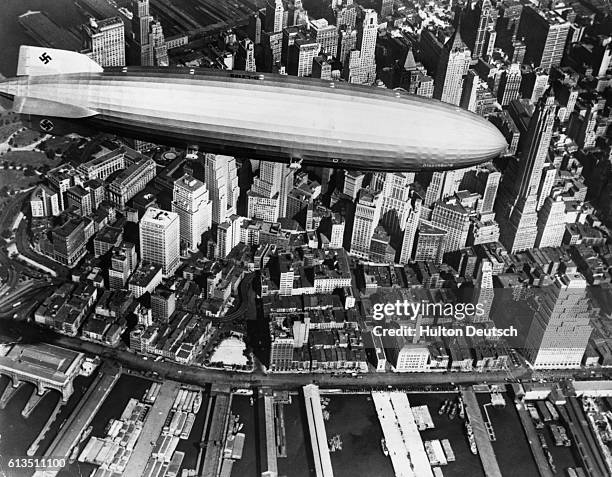 The German airship, the Hindenburg, above Manhattan, New York in 1936, on its way to its berth at Lakehurst , New Jersey, the same place where it...