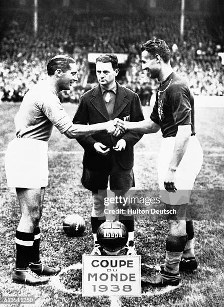 At the start of the 1938 World Cup Final in Paris between winners Italy and Hungary, Italy's Meazza and Hungarian team captain Sarosi shake hands as...