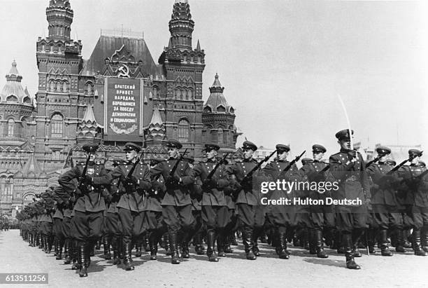 Soldiers in the Red Army march in a May Day parade outside of the State Historical Museum, Moscow