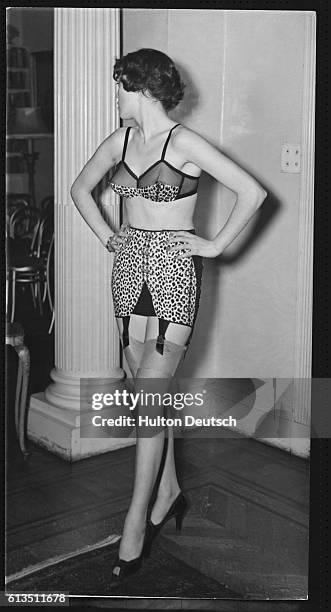 Woman models underwear by Belinda Bellville and Synda Scott at a show of their autumn collection. She wears a leopard print brassiere and girdle with...