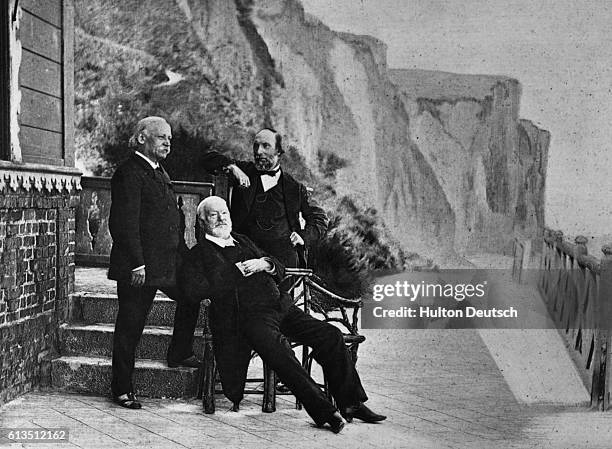 The elderly poet and writer Victor Marie Hugo , with friends on the balcony of his home in Guernsey in the Channel Islands, where he lived in exile...