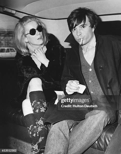 Catherine Deneuve, film star, with her husband, photographer David Bailey at London Airport in 1966.