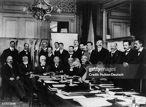 Albert Einstein and Marie Curie amongst a group of fellow scientists at a conference in Brussels. Seated : W. Nernst, M. Brillouin, E. Solvay, H....