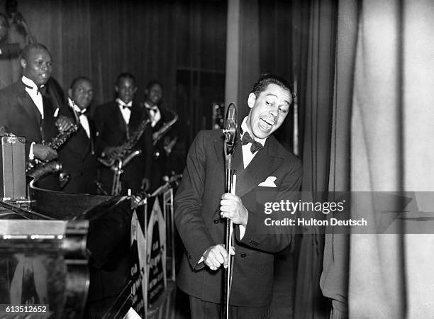 The American jazz musician and bandleader Cab Calloway, performing with his orchestra at the Elephant and Castle Trocadero in London.