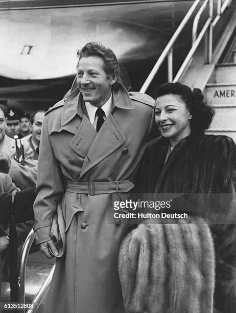 American actor, singer and comedian Danny Kaye arrives with his wife, Sylvia Fine, for an appearance in London. November 1948.
