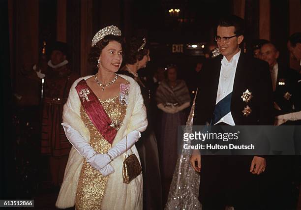Queen Elizabeth II and King Baudouin of Belgium attend a performance at the Royal Opera House in Covent Garden. London, England, May 1963.