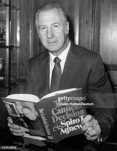 The former American vice-President Spiro Agnew displays a copy of his novel The Canfield Decision.