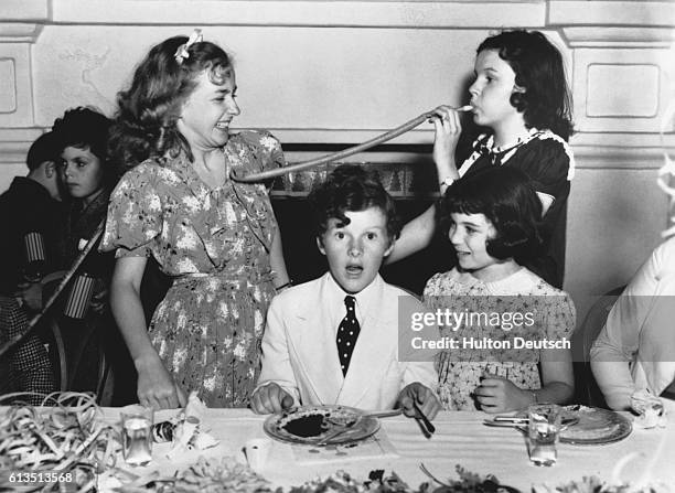American child actors at a birthday party for one of the studio children, circa 1938. Left to right: Dickie Moore, Bonita Granville, Tommy Kelly,...