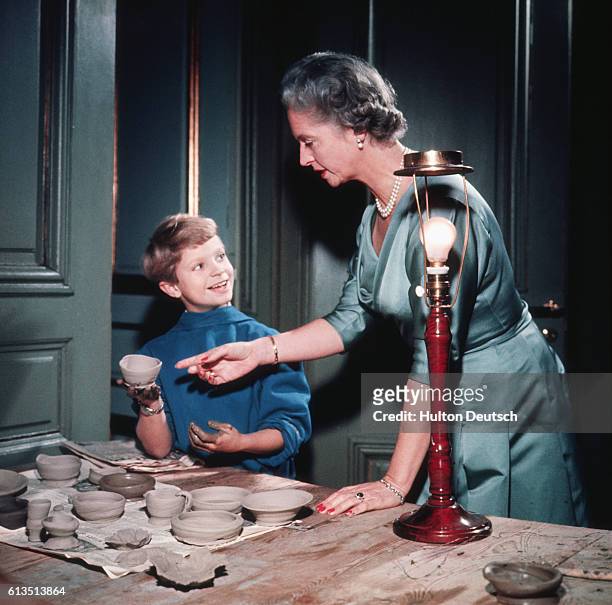 Prince Carl Gustav shows his mother Princess Sibylla the pottery he's making.
