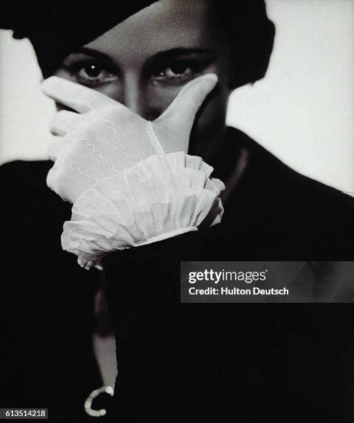 Young woman models a pair of frilly, lace, gloves.