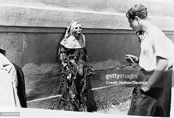 The corpse of a Carmelite nun on public display in Barcelona, Spain, during the Spanish Civil War, July 1936. | Location: Barcelona, Spain.