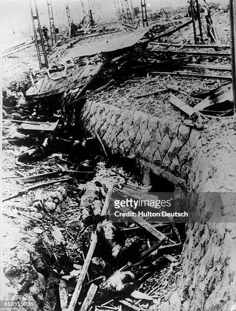 The bodies of the passengers of a destroyed tram car lay in the ditch, covered in rubble, after the explosion of the atomic bomb on Nagasaki. |...