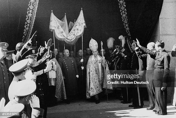 General Franciso Franco, the dictator of Spain, leaves the requiem of the late King Alphonso XIII under a canopy and accompanied by the bishop. |...