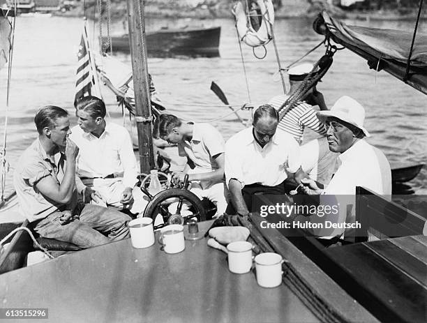Governor Franklin D. Roosevelt with family on his yawl Myth, off of Marblehead. From left to right, nephew Robert Delano, sons Franklin Delano, Jr.,...