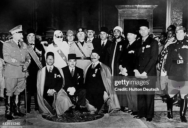 Benito Mussolini meets with Abyssinian "chieftains", many of whom look distinctly European, during Il Duce's conquest of Abyssinia. The meeting took...