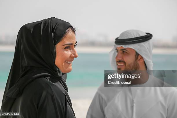 arab couple with traditional wear on the beach - bahrain people stock pictures, royalty-free photos & images