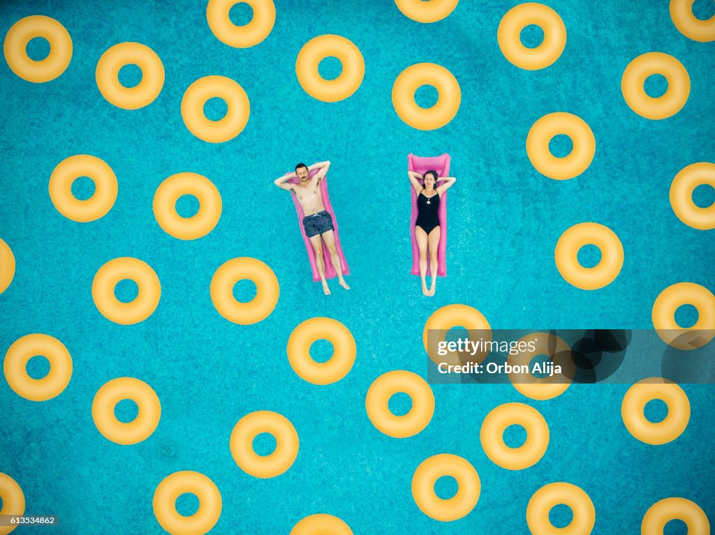 Couplen on ring in swimming pool