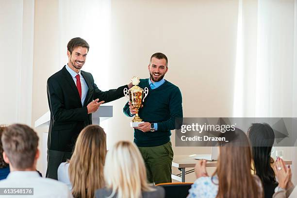 president gives trophy to winner in business - employee of the month stock pictures, royalty-free photos & images